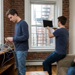 Students improving Wi Fi speed in shared Boston apartment