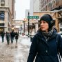 Person wearing noise cancelling headphones outdoors during a snowy Chicago winter day.